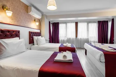 a hotel room with two beds with towels on them at Cihangir Palace Hotel in Istanbul