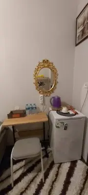 a room with a table and a mirror and a refrigerator at Fener sweet in Istanbul