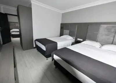 a hotel room with two beds and a bathroom at Sahil Hotel Pendik in Tuzla