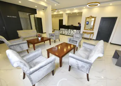 a lobby with chairs and tables and a mirror at Sahil Hotel Pendik in Tuzla