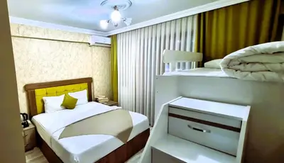 a small bedroom with a bed and two bunk beds at WİND HOTEL in Sakarya