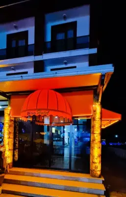a building with a red umbrella in front of it at WİND HOTEL in Sakarya