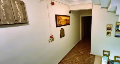 a hallway with paintings and pictures on a wall at WİND HOTEL in Sakarya