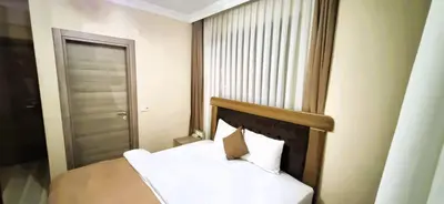 a small bedroom with a bed and a window at WİND HOTEL in Sakarya