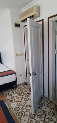 a room with a door and a bedroom with a bed at Hotel Nova in Istanbul