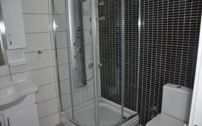 a bathroom with a shower with a toilet and a sink at ELMİR SUİTES Hotel in Istanbul