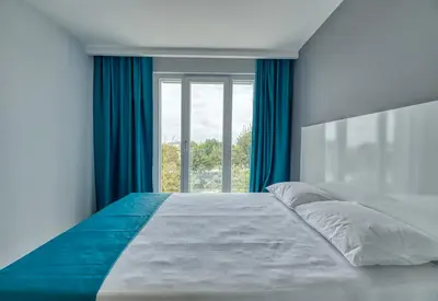 a bedroom with a large bed with a window at Grisverde Suites in Istanbul