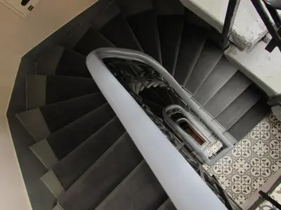 a spiral stair case with a silver hand rail at Louis Appartements Galata in Istanbul