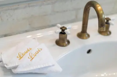 a bathroom sink with a white towel with the words slow down at Louis Appartements Galata in Istanbul