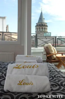 a hotel room with towels on a bed with a tower at Louis Appartements Galata in Istanbul