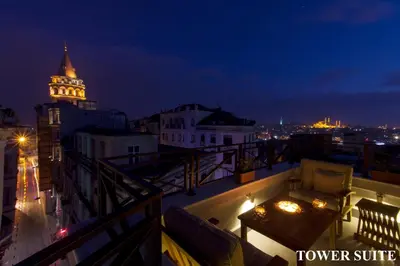 a balcony with a view of a city at night at Louis Appartements Galata in Istanbul