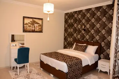 a bedroom with a bed and a wall at Şar Apartment Suites in Istanbul