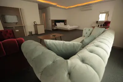 a living room with a white couch and a table at TEVETOGLU HOTEL in Istanbul