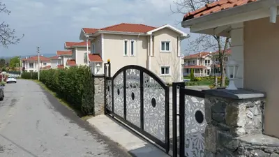 a black iron gate in front of a house at PALACE KIRKPINAR in Sakarya