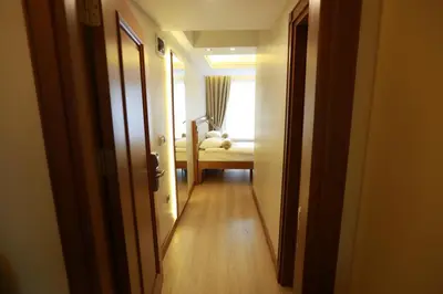 a hallway leading to a room with a bed in the distance at Sirkeci Park Hotel in Istanbul