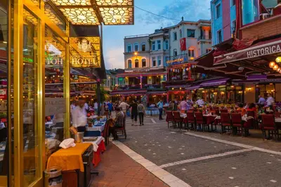 a street with tables and chairs and people walking down a street at Golden Sand Hotel in Istanbul