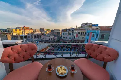 a balcony with two chairs and a table with a plate of food at Golden Sand Hotel in Istanbul
