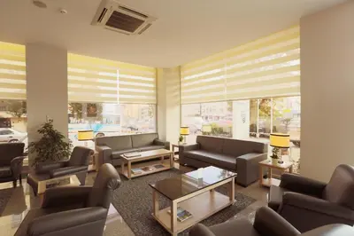 a living room with couches and tables and windows at Hotel Expocity Istanbul in Avcılar