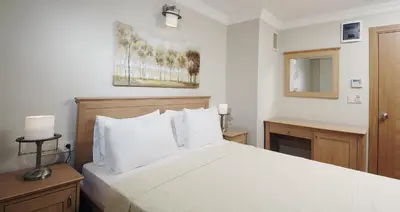 a bedroom with a white bed with white pillows at Hotel Expocity Istanbul in Avcılar