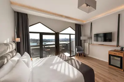 a hotel room with a bed and a balcony at DORUK PALAS HOTEL in Istanbul