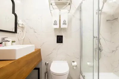 a bathroom with a shower and a toilet and a sink at DORUK PALAS HOTEL in Istanbul