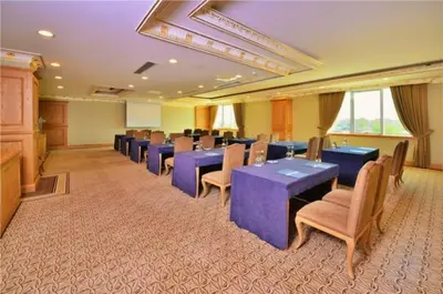 a conference room with tables and chairs and a podium at The Sign Kocaeli Thermal Spa Hotel &Convention Center in Yeniköy