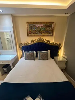 a bedroom with a large bed with a blue headboard at Hotel Barbarosa in Istanbul