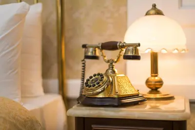 a telephone sitting on a table next to a lamp at Darussaade Hotel Old City - Sultanahmet in Istanbul
