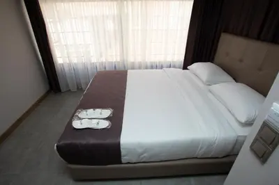 a bedroom with a large bed with two towels on it at Jurnal Hotel in Istanbul