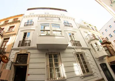 a white building with windows on a city street at Jurnal Hotel in Istanbul