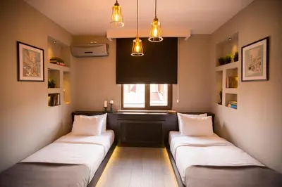 two beds in a room with a window at Cityloft 36 in Istanbul