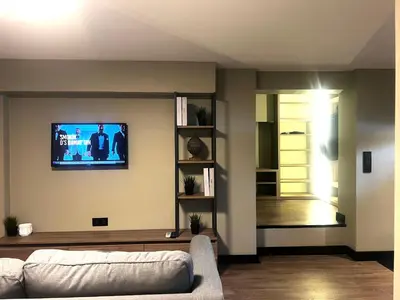 a living room with a couch and a tv on the wall at Cityloft 36 in Istanbul
