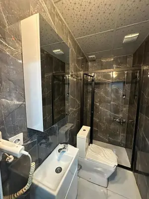 a bathroom with a sink and a shower and a toilet at Modena Hotel in Istanbul
