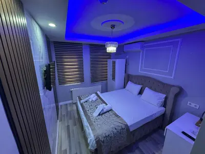 a small bedroom with a bed with a purple ceiling at Modena Hotel in Istanbul