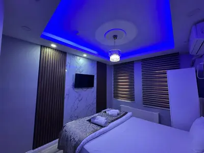 a bedroom with a bed with a blue lighting at Modena Hotel in Istanbul