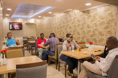 a group of people sitting at tables in a restaurant at Hotel Bestur in Istanbul