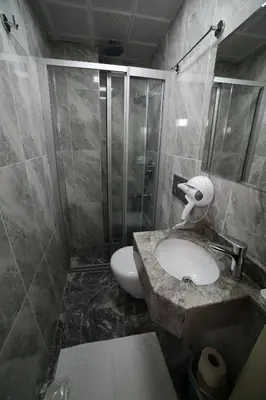 a bathroom with a toilet and a sink and a shower at taksim diamond hotel in Istanbul