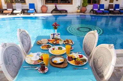 a tray of food on a table next to a swimming pool at Seven Hills Palace & Spa in Istanbul