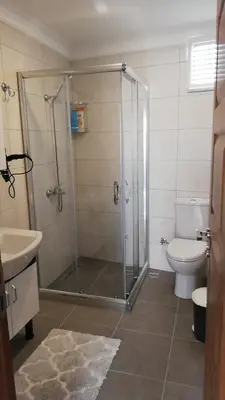 a bathroom with a shower and a toilet at Little Palace Blue Apartment in Istanbul