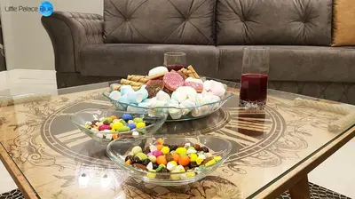 a table with three bowls of candies on top at Little Palace Blue Apartment in Istanbul