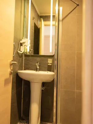 a bathroom with a sink and a mirror at THE LAİLA HOTEL in Istanbul