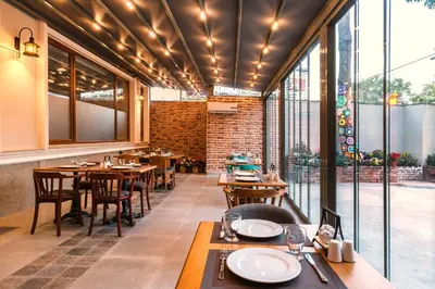 a restaurant with tables and chairs and large windows at Obelisk Hotel & Suites in Istanbul