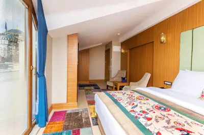 a bedroom with a bed and a window at Obelisk Hotel & Suites in Istanbul