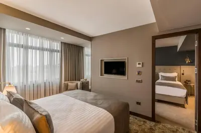 a hotel room with two beds and a mirror at Galata Times Hotel in Istanbul