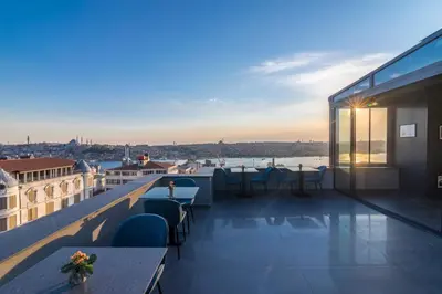 a balcony with tables and chairs on a building at Galata Times Hotel in Istanbul