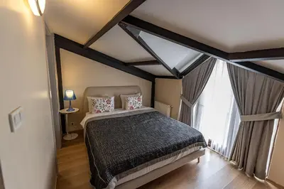 a bedroom with a bed and a large window at Calanthe Residence in Istanbul