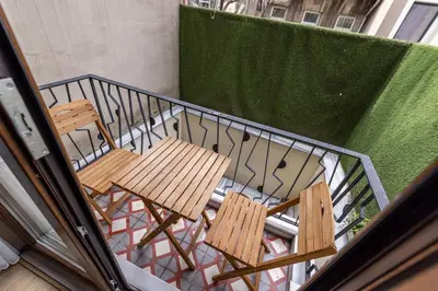 two chairs sitting on a balcony with a railing at Calanthe Residence in Istanbul