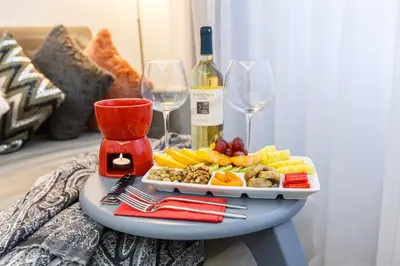 a table with a plate of food and wine glasses at Sadaret Suites-Old City Sultanahmet in Istanbul
