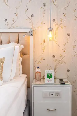 a bedroom with a bed and a nightstand with a clock at Sadaret Suites-Old City Sultanahmet in Istanbul