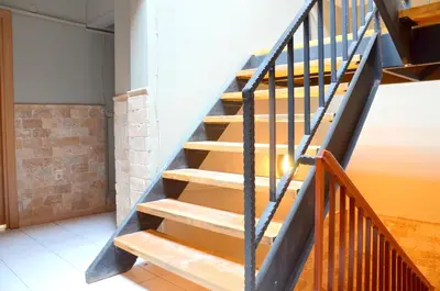a staircase in a room with a brick wall at Elite Hotel City Center Saray Bed and Breakfast in Saray